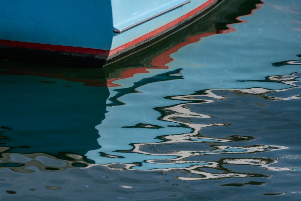 white red and blue boat on water