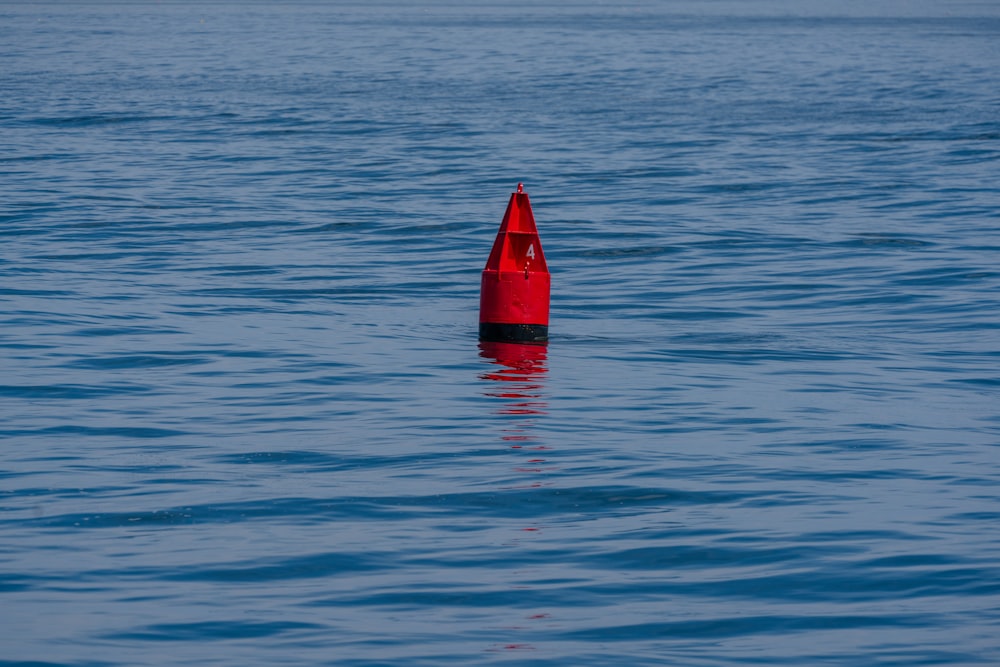 red sail boat on blue sea during daytime