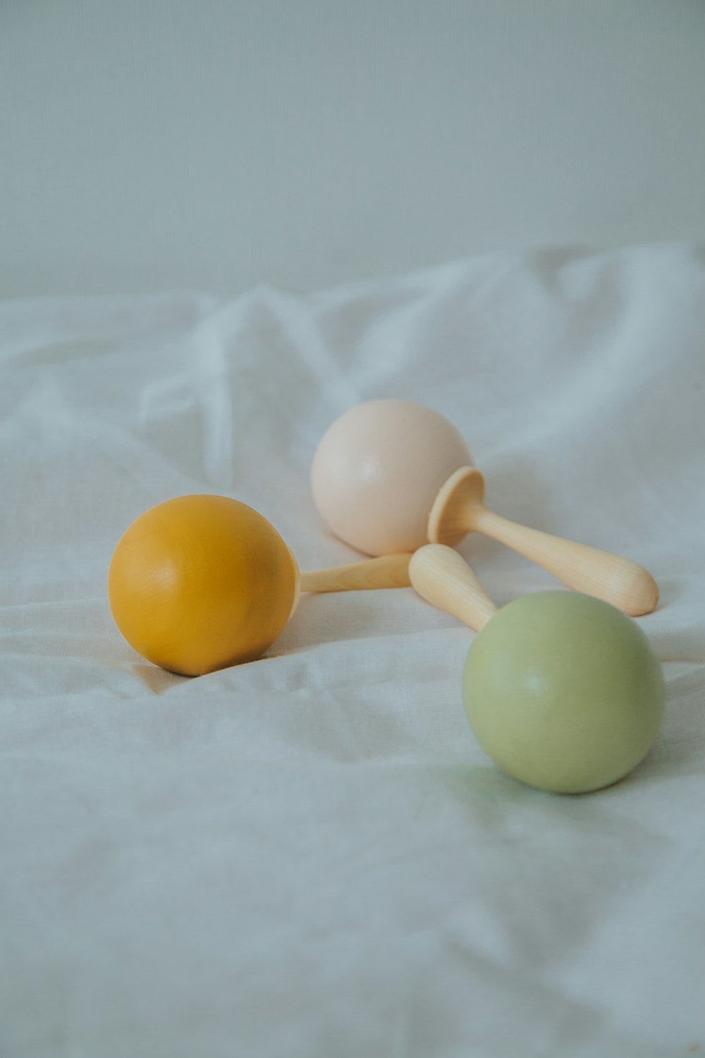 yellow egg beside yellow egg on white textile