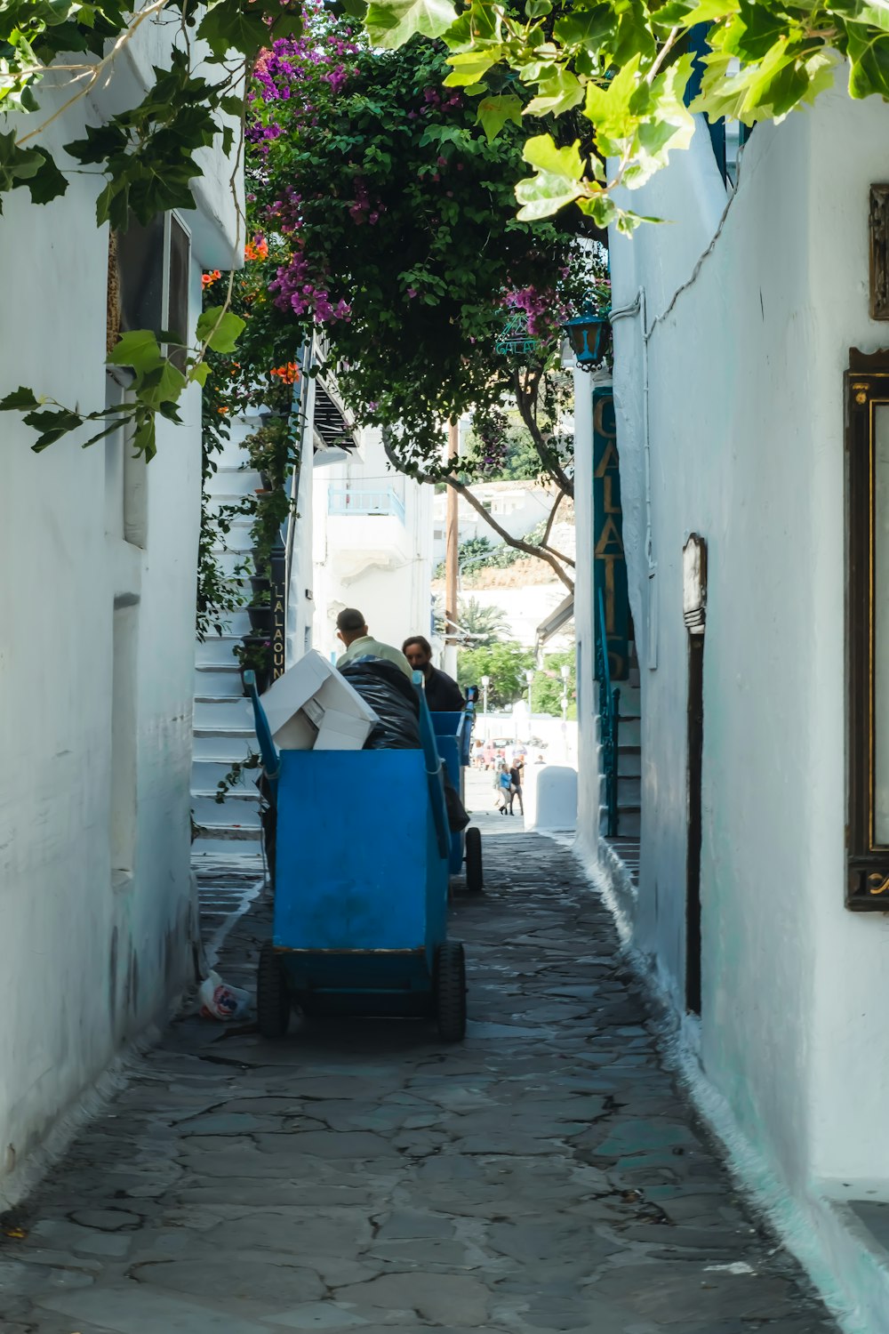 man in black jacket sitting on blue plastic chair