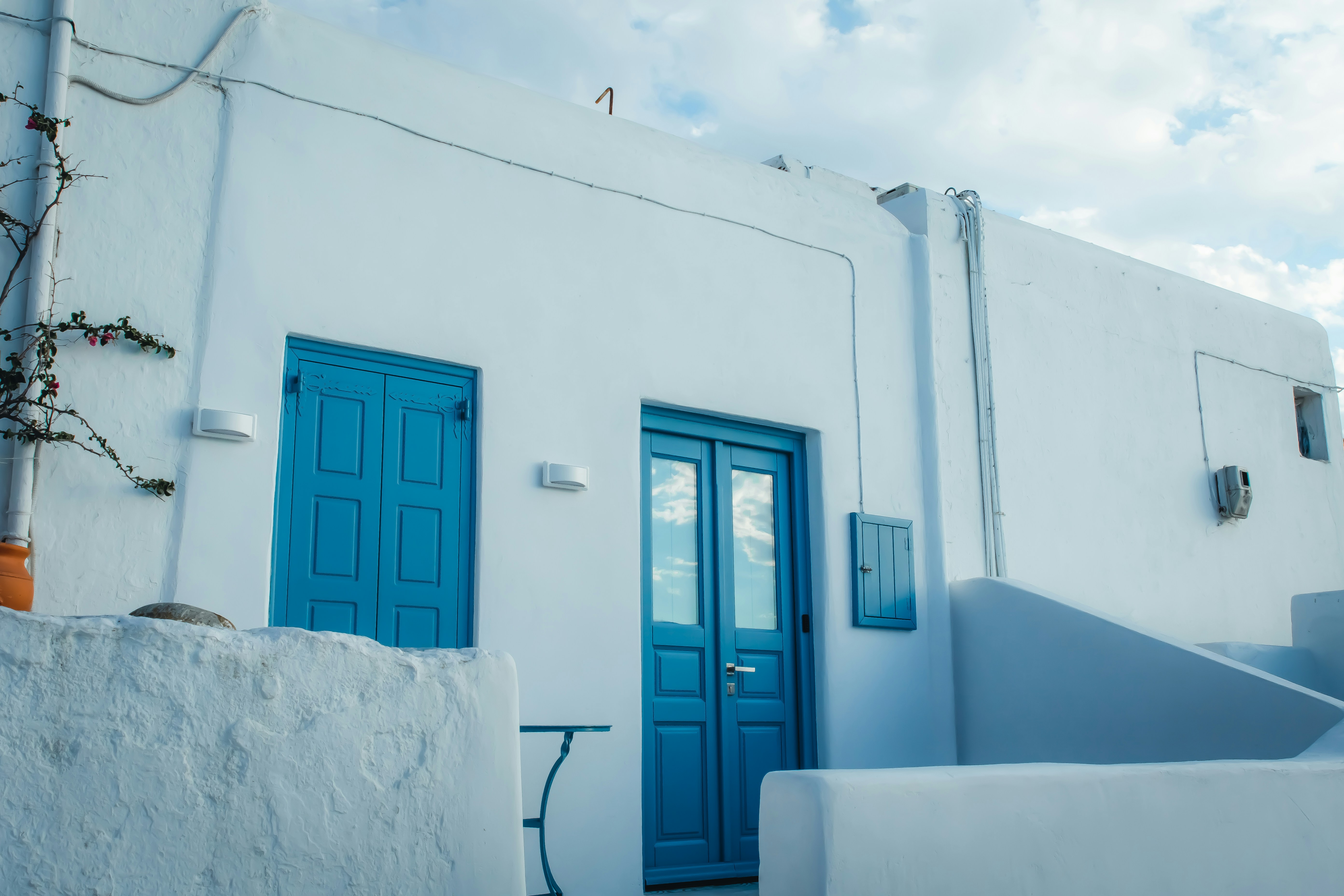 blue wooden door on white concrete building