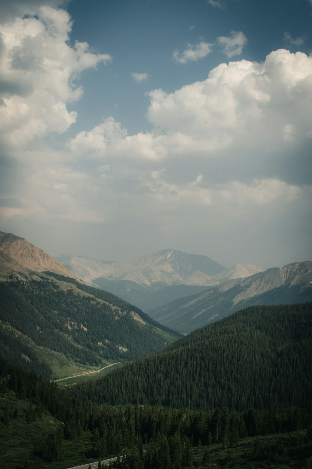 green mountains under white clouds during daytime