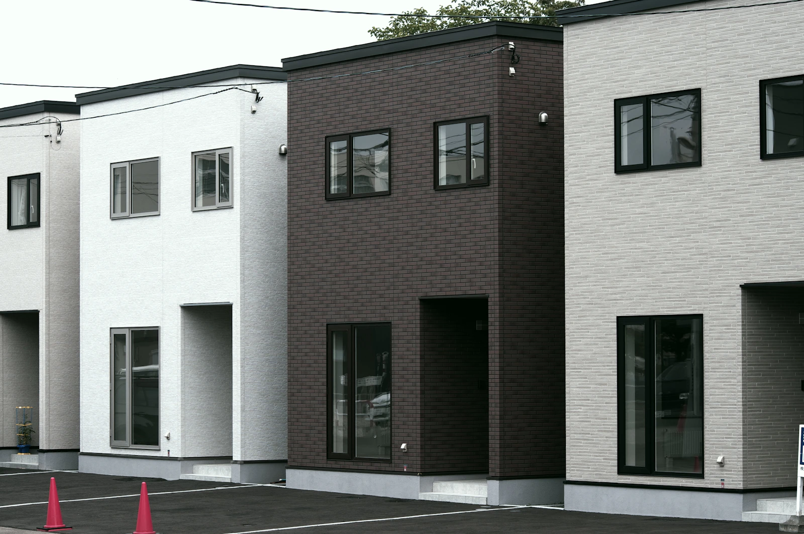 Contemporary residences with contrasting light and dark facades; stock architectural inspiration