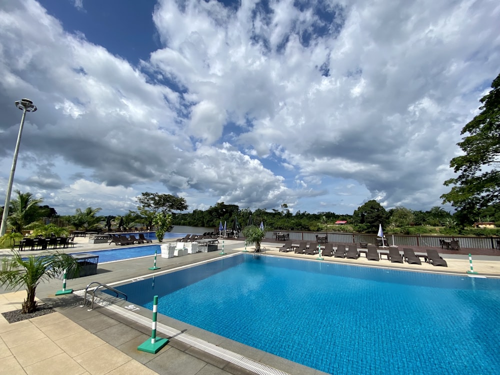 swimming pool under cloudy sky during daytime