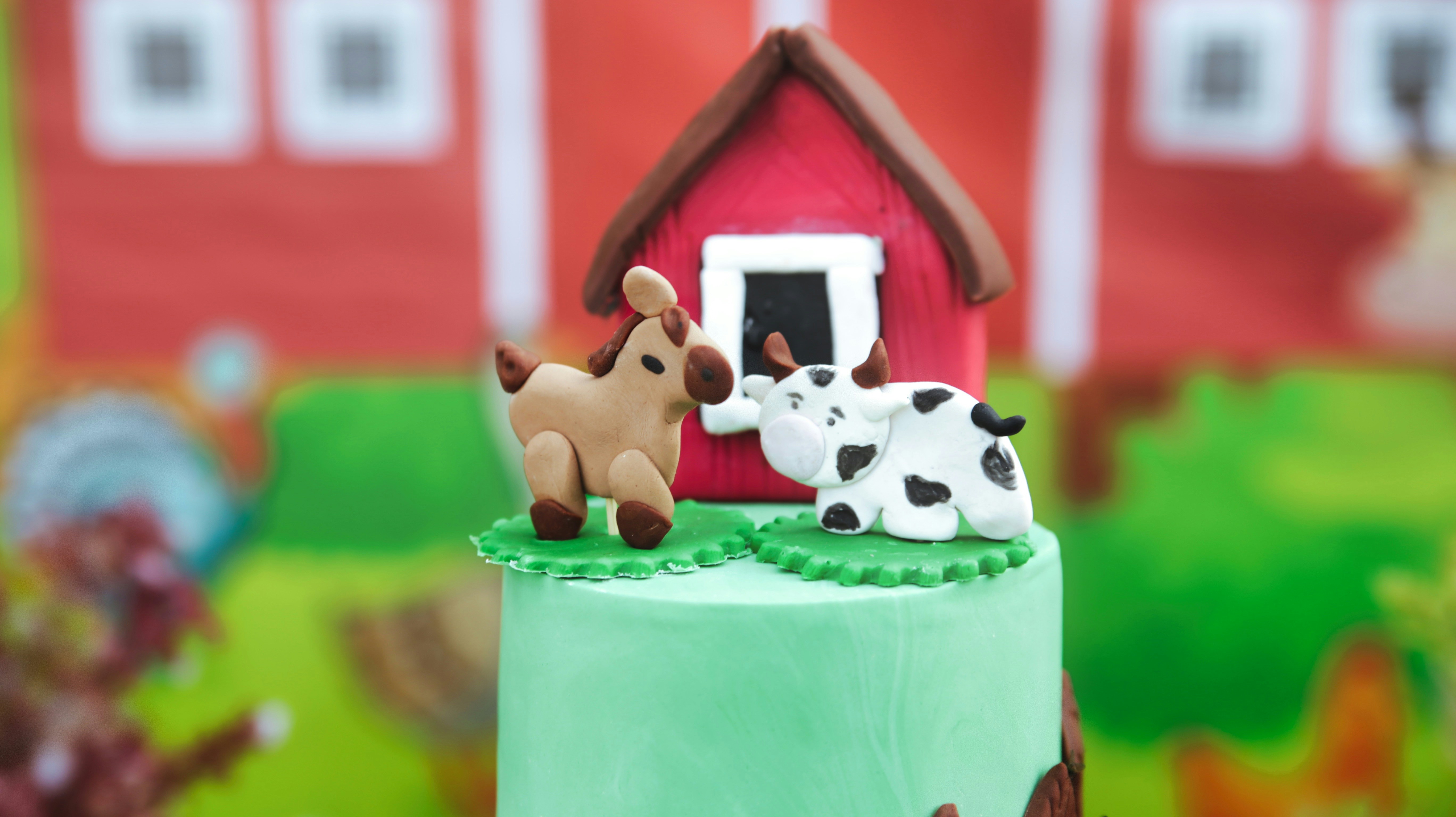 white and brown dog on green and white cake