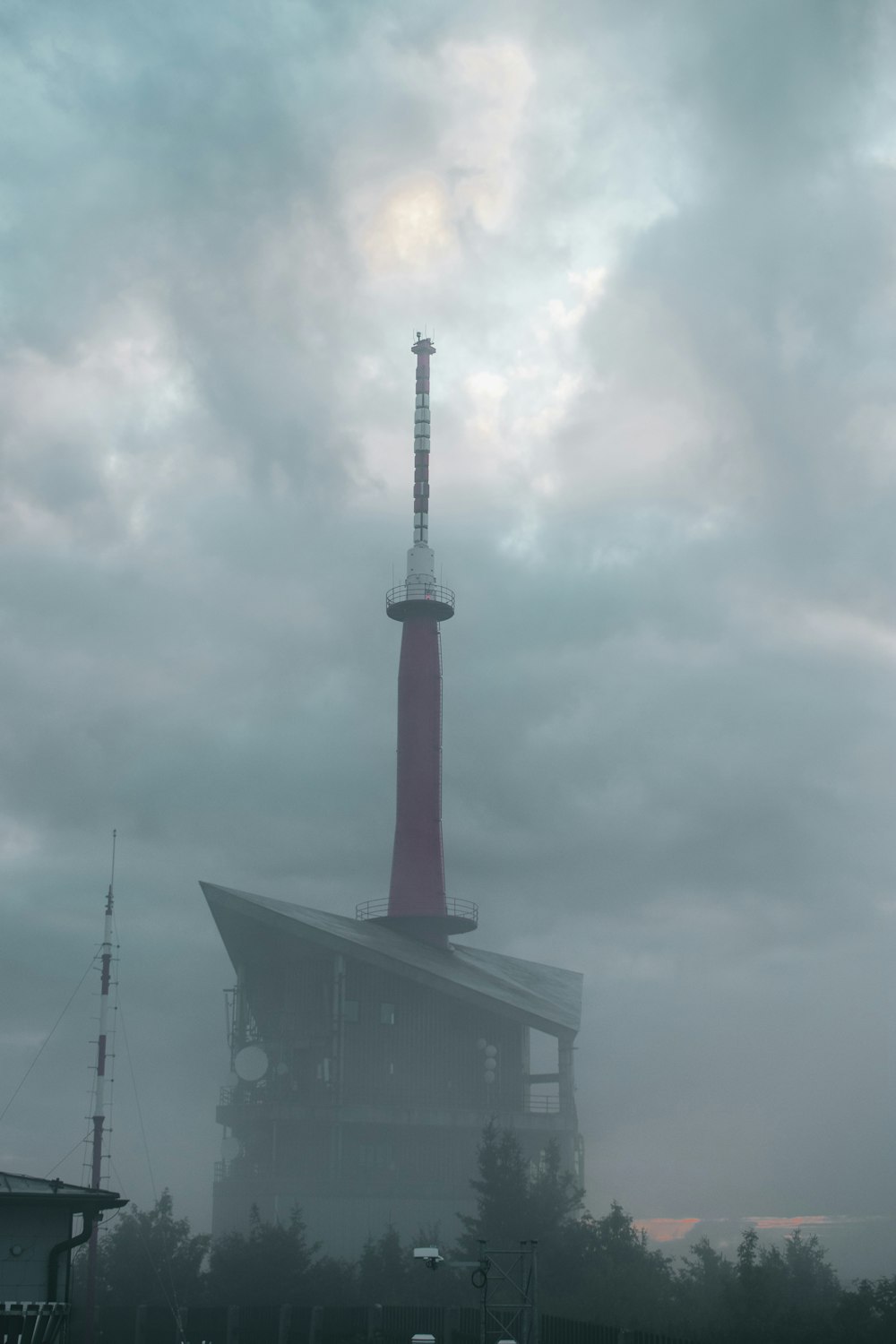 red and white tower under cloudy sky