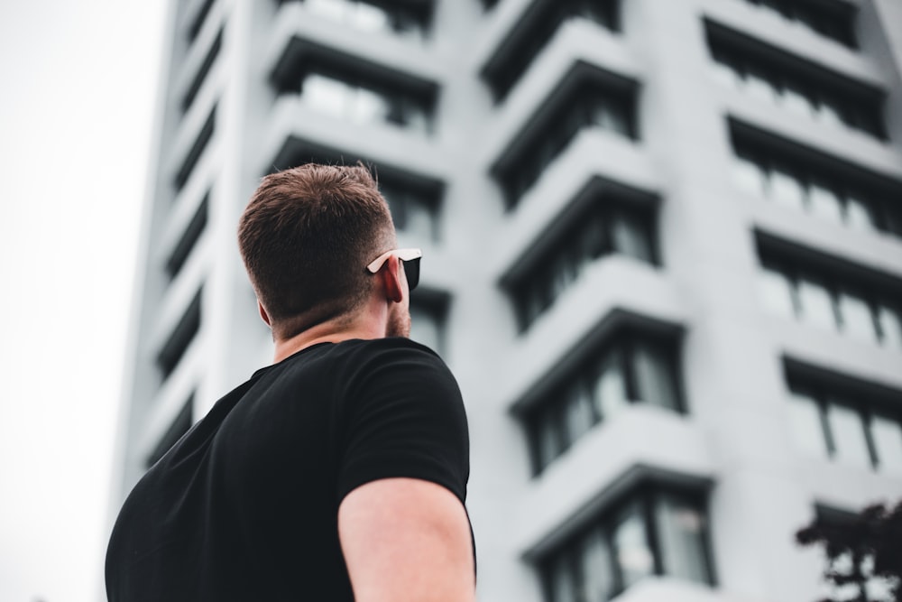 man in black crew neck t-shirt wearing black sunglasses