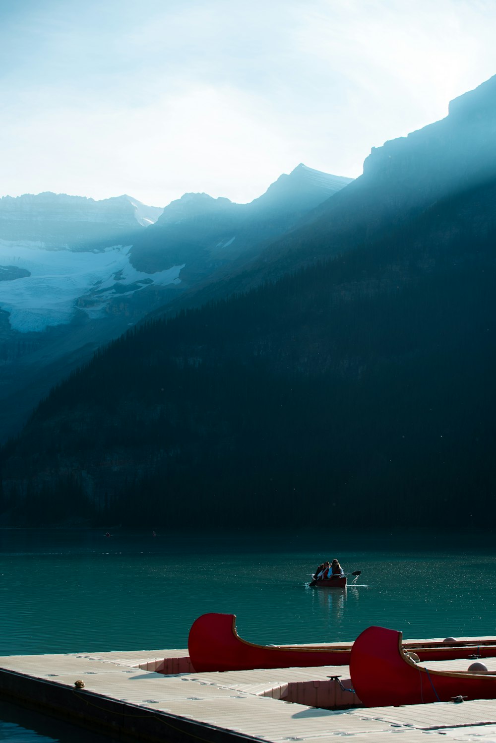 2 people on boat on lake during daytime
