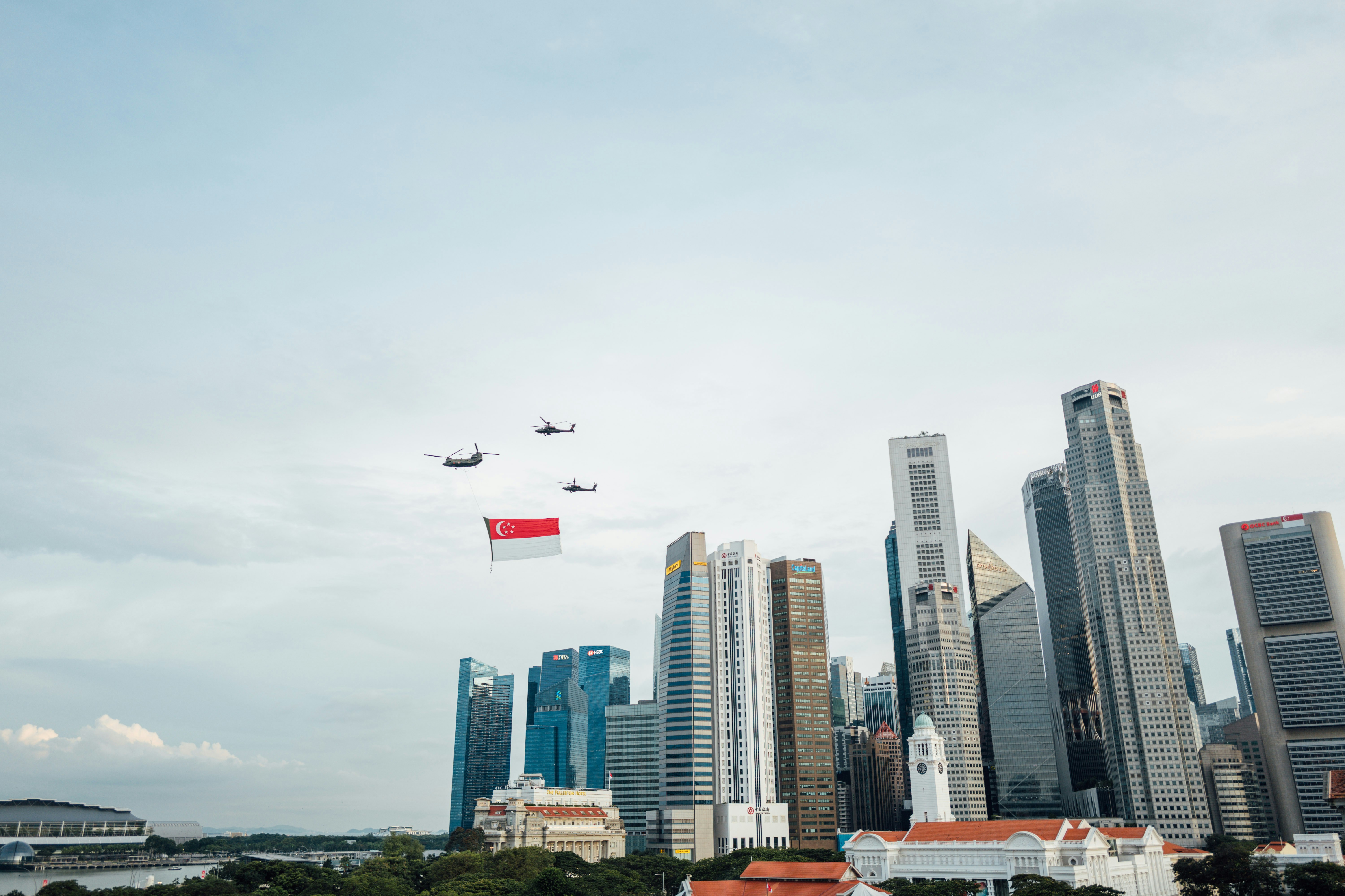 airplane flying over city buildings during daytime