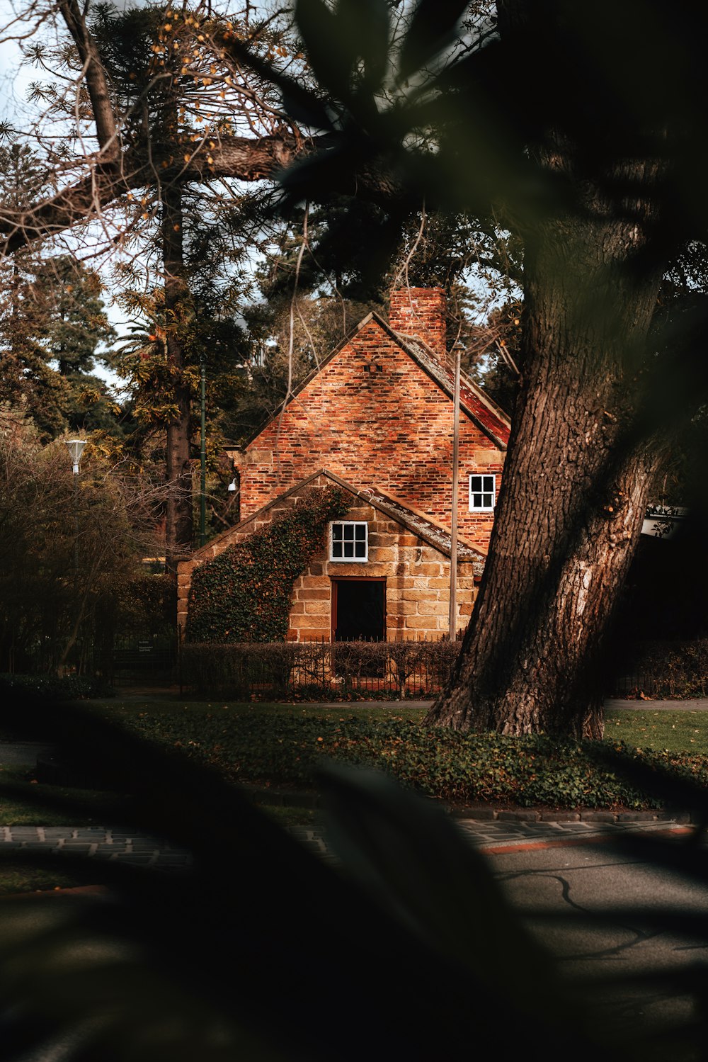 brown concrete house near trees during daytime