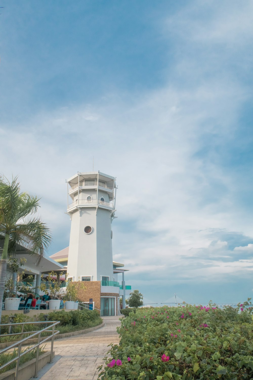 white concrete tower under white clouds during daytime