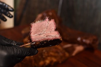 person holding grilled meat during daytime