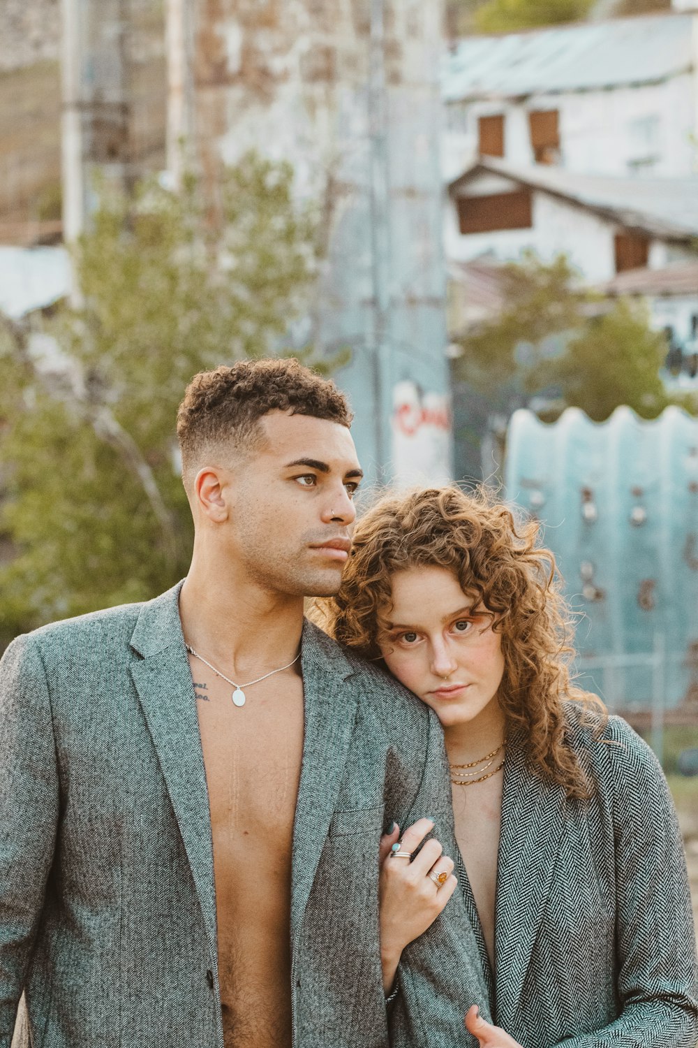 man in gray suit jacket beside woman in gray blazer