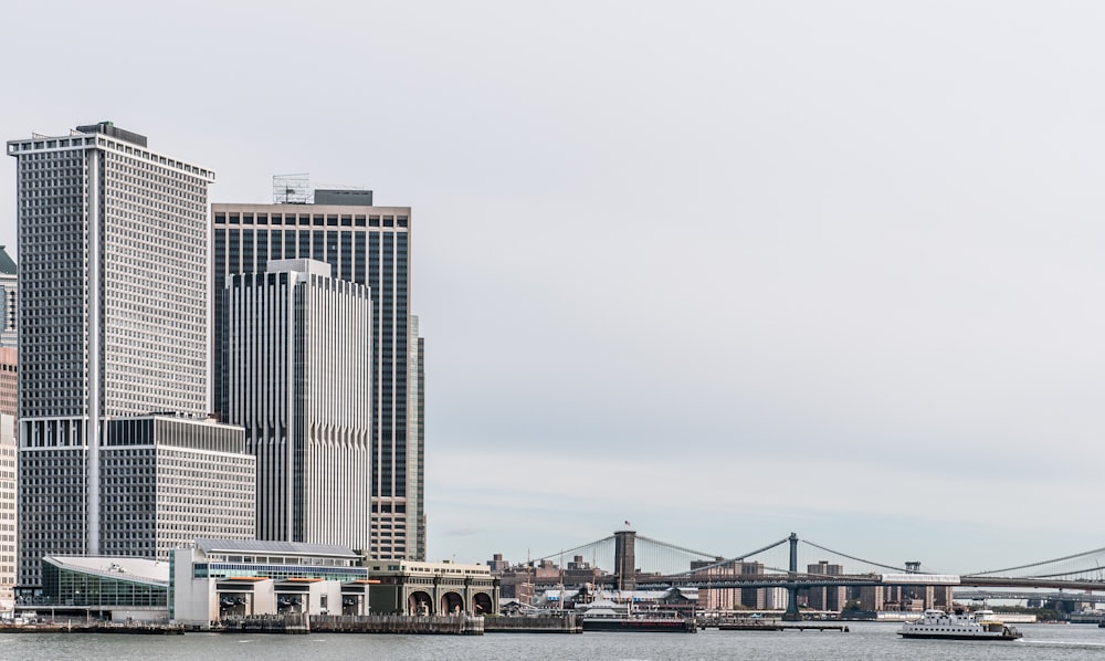 white and blue high rise buildings near body of water during daytime