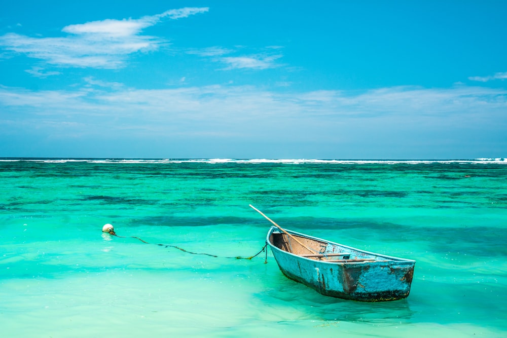 people swimming on sea during daytime