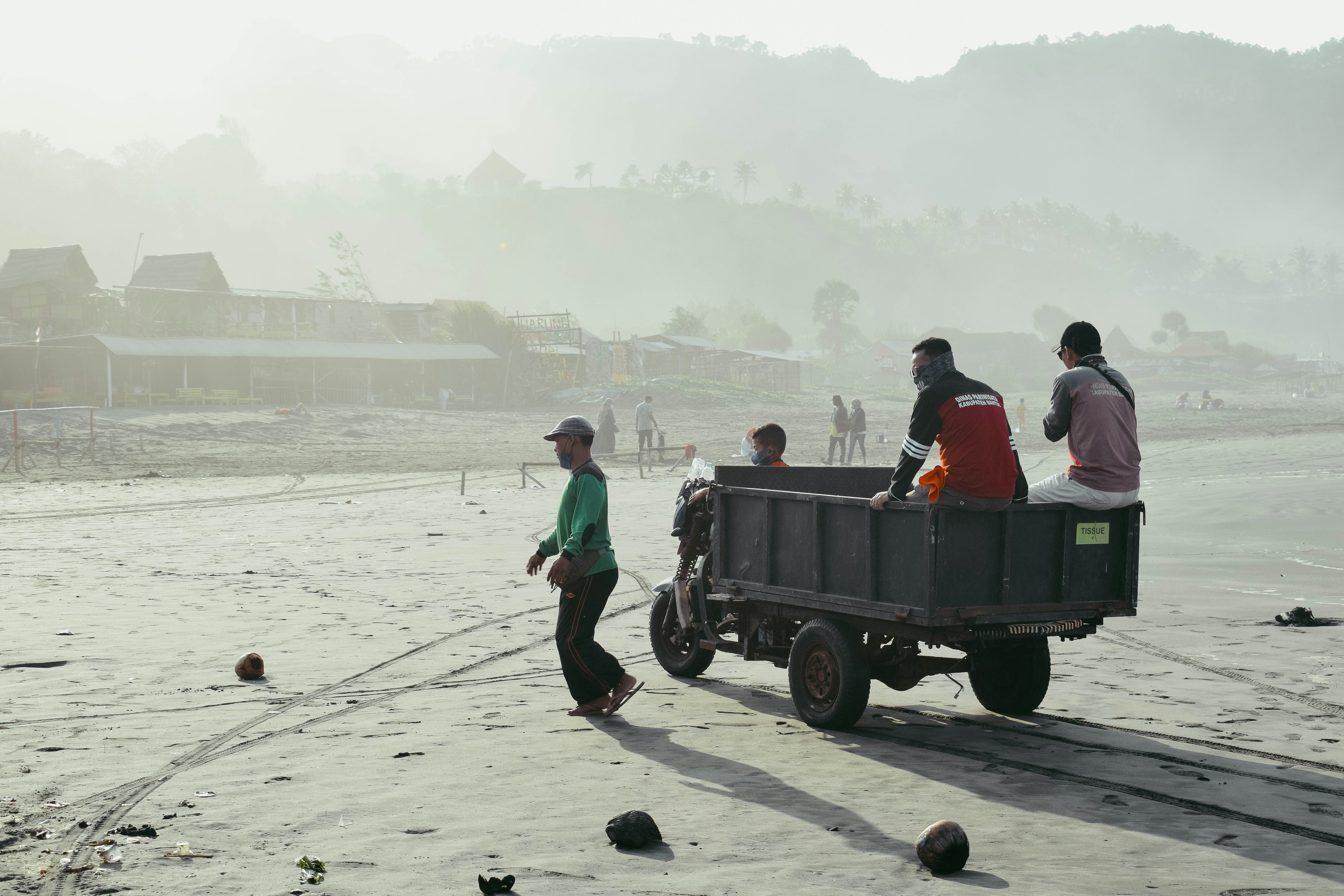 people riding on green car during daytime