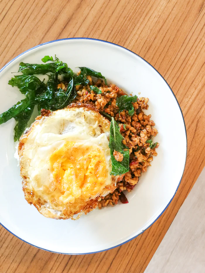 Thai basil chicken over rice with a fried egg