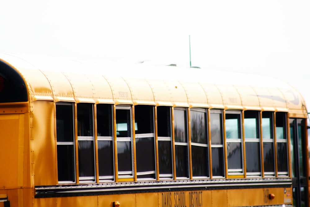 yellow and white bus under white sky during daytime