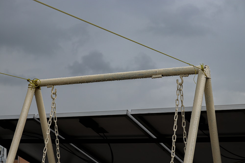 a metal swing with a chain attached to it