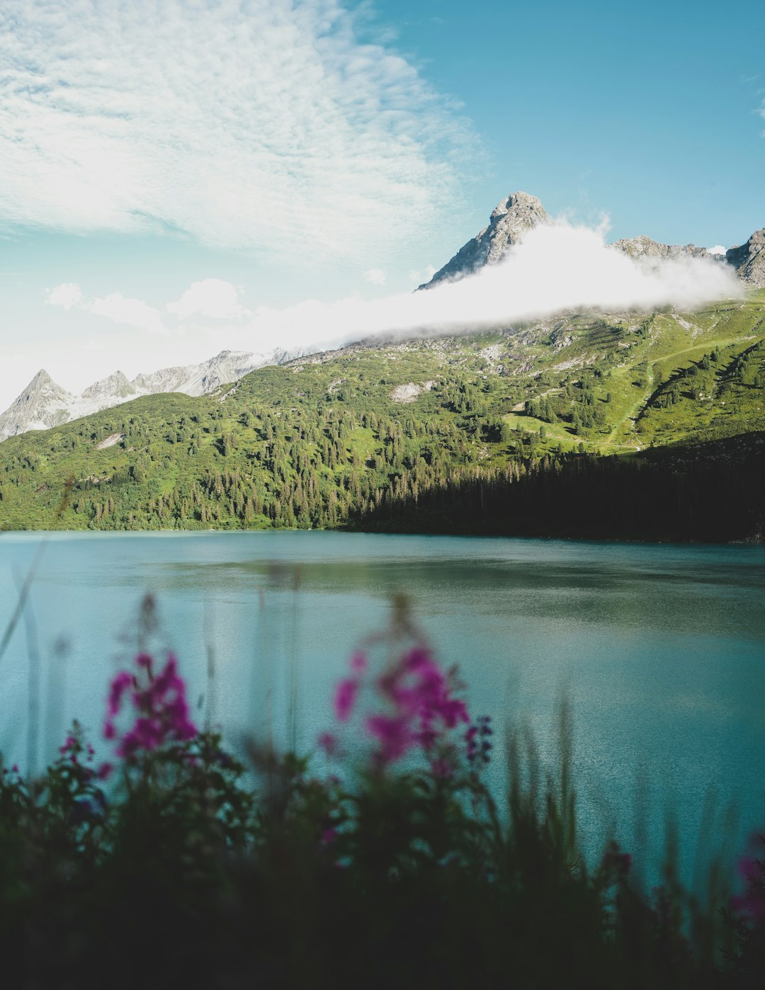 lake near snow covered mountain