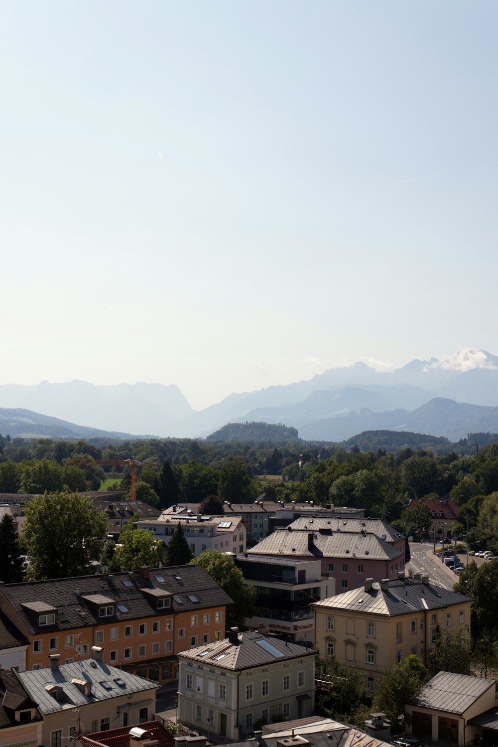 brown and white houses near green mountains during daytime