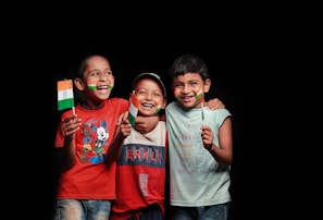 2 boys wearing gray and red crew neck t-shirts