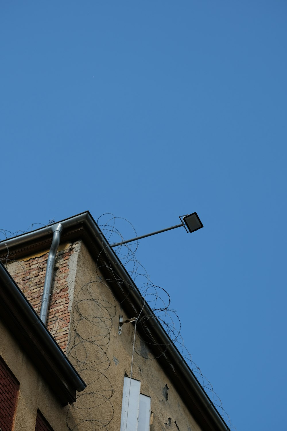 black street light on brown concrete building during daytime