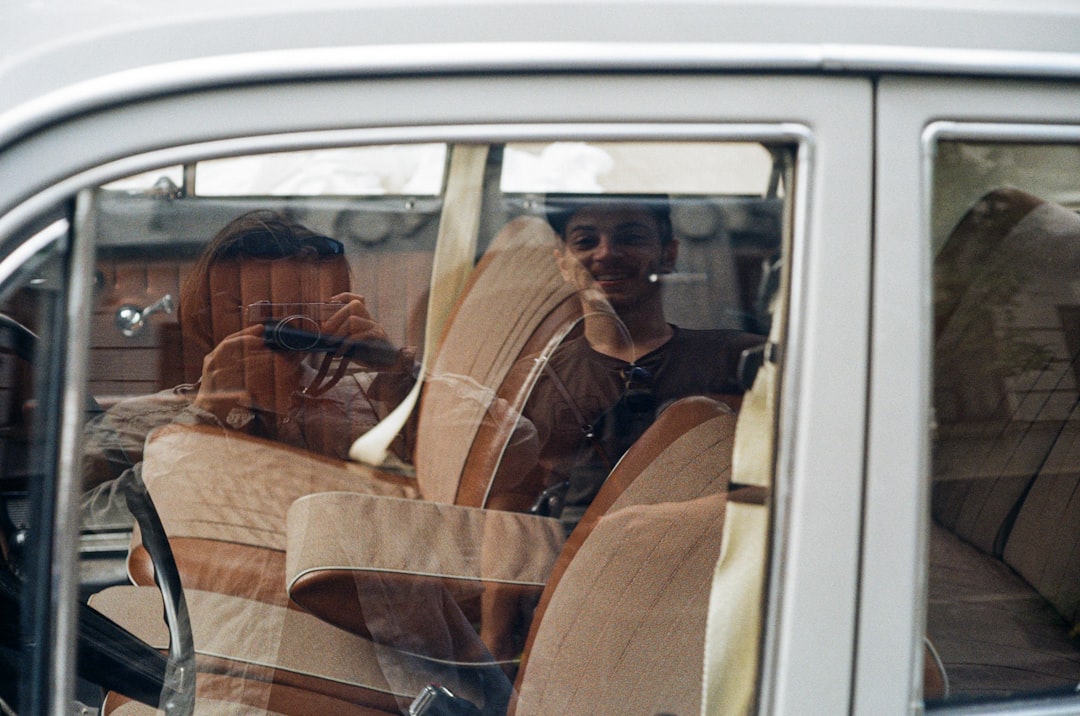 woman in brown jacket sitting on brown car seat