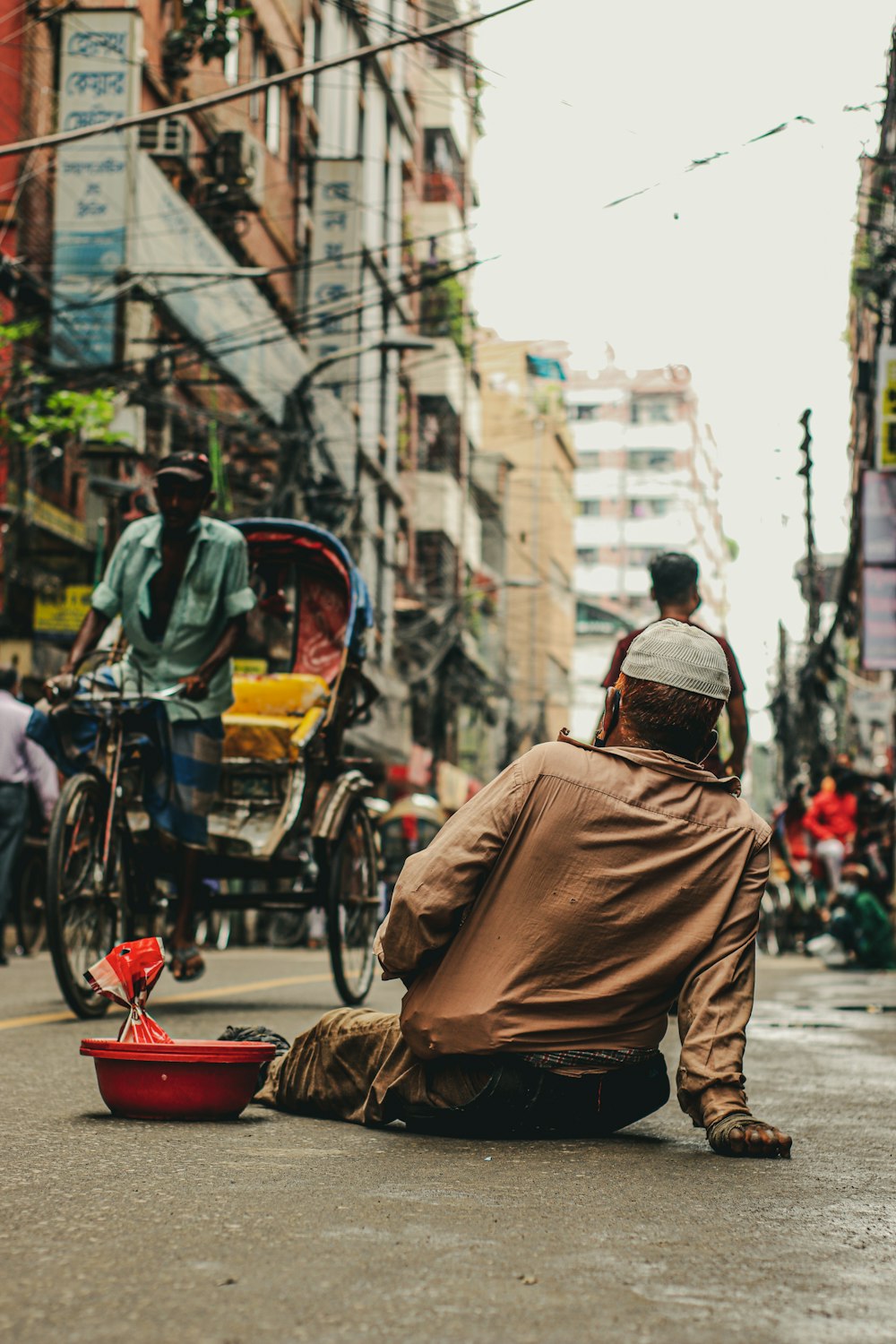 man in brown jacket and brown backpack riding bicycle on street during daytime