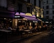 people sitting on chairs near building during night time