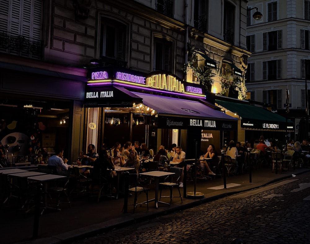 people sitting on chairs near building during night time