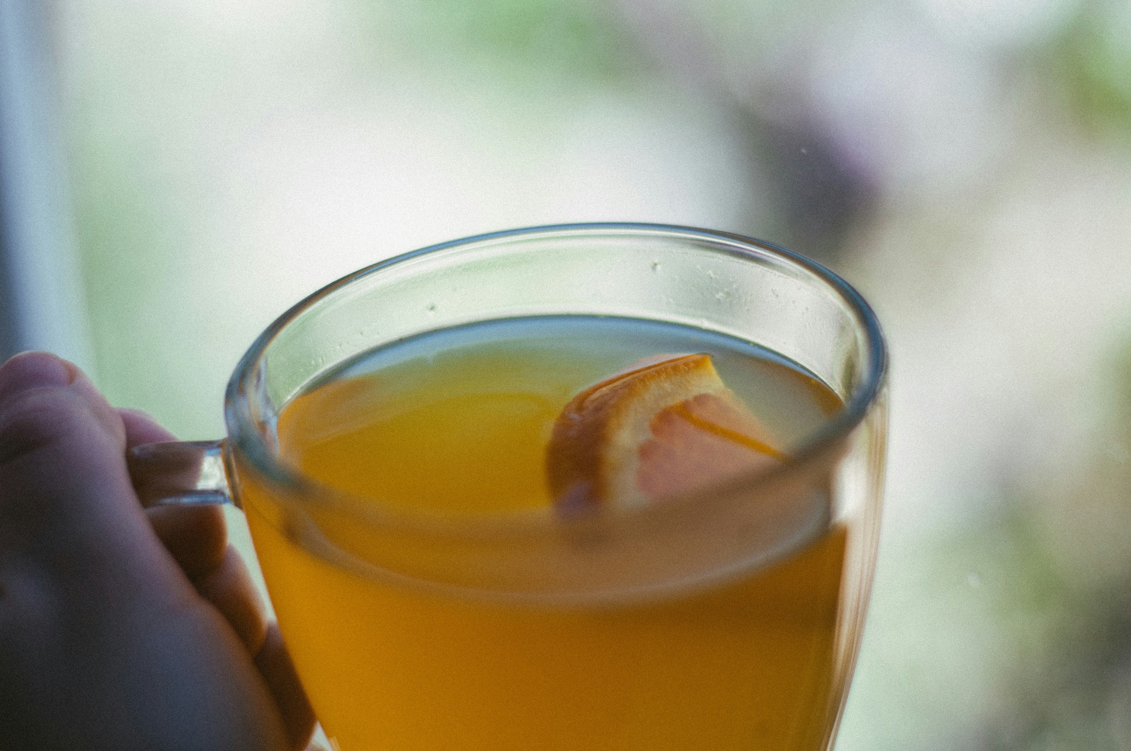 clear glass cup with yellow liquid