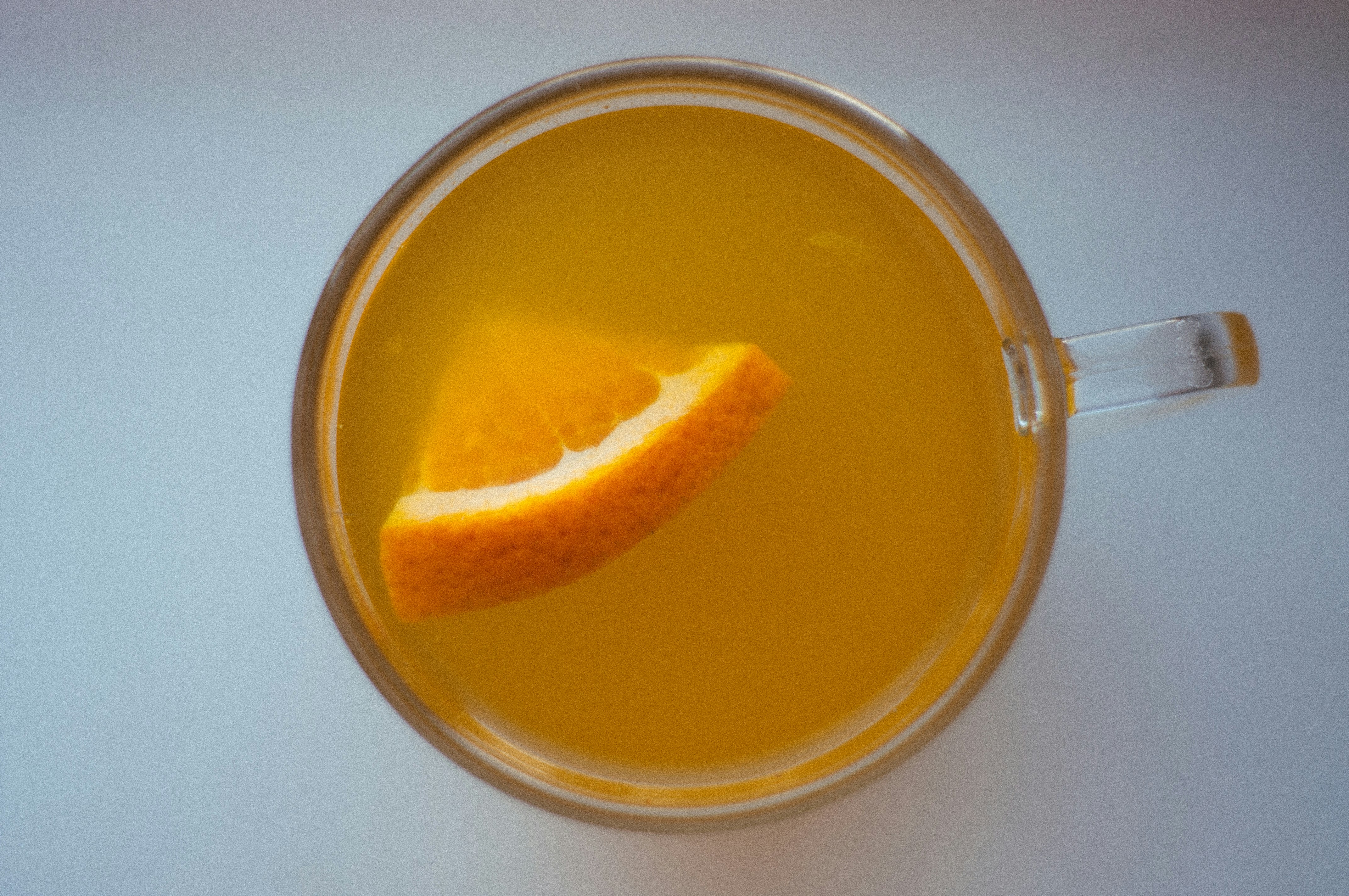 orange juice in clear glass mug