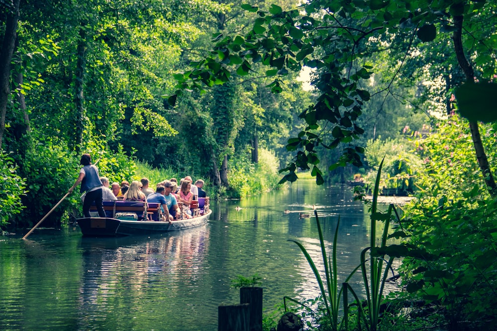 people riding boat on river during daytime