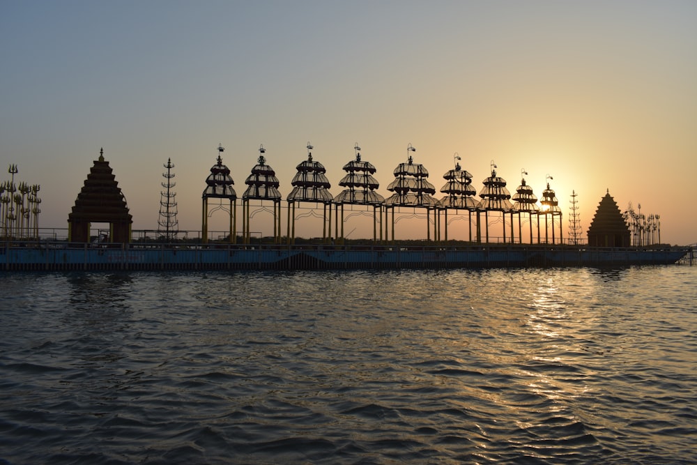 silhouette of people walking on bridge during sunset