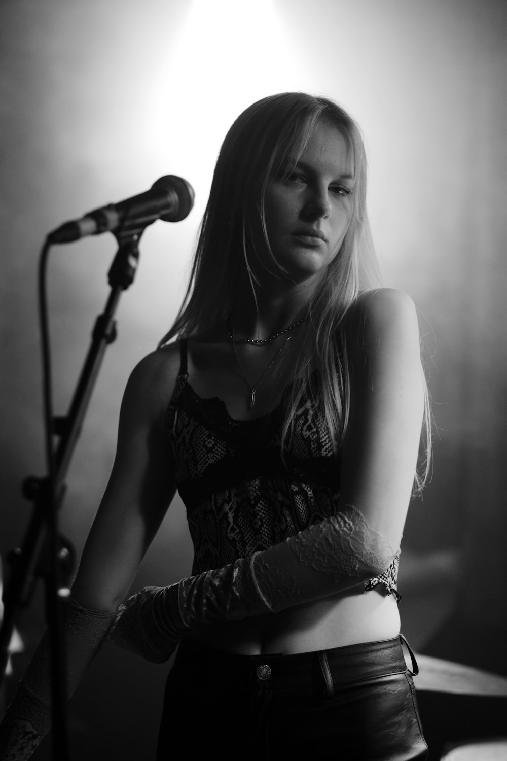 woman in black and white floral dress singing