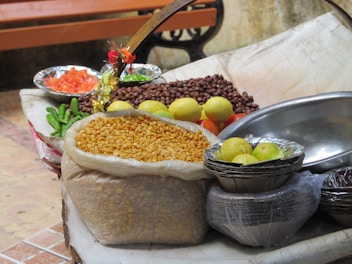 Fresh organic fruits and grains used in Ayurvedic recipes displayed on rustic cloth.
