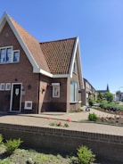 Image showing a completed residential brick house with a garden.