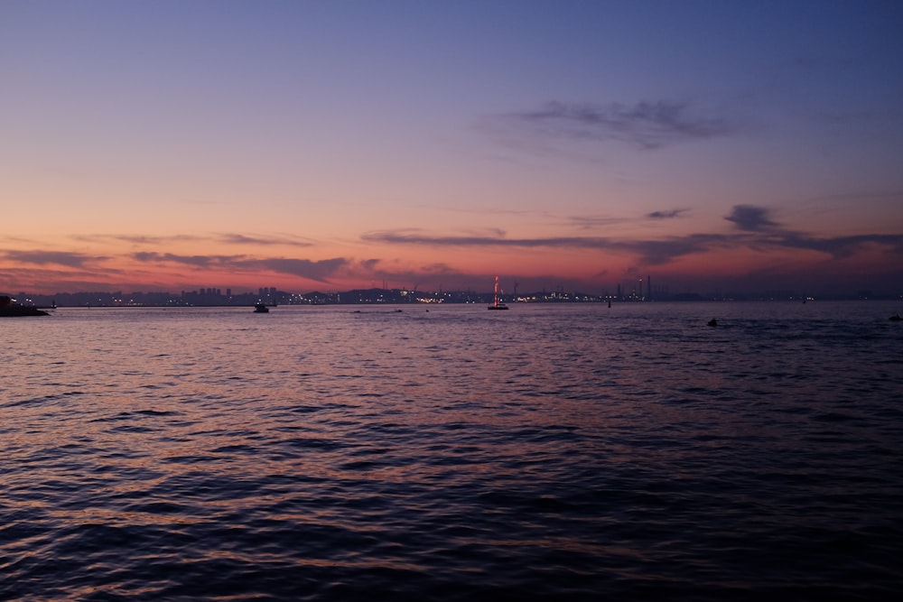 body of water during sunset