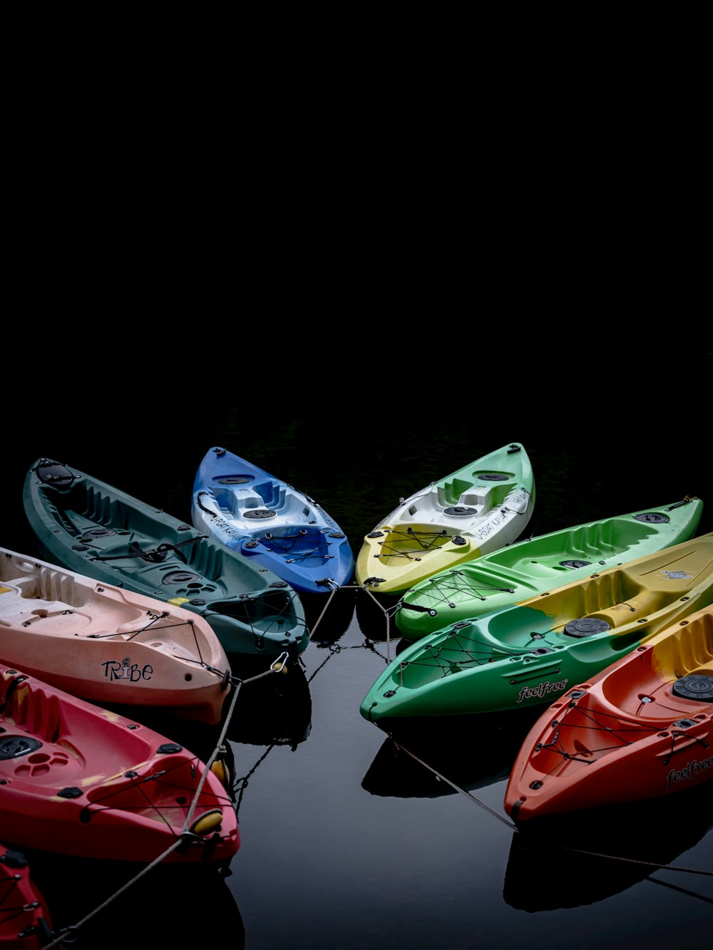 assorted color kayak on black surface