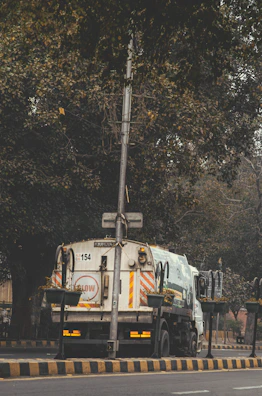 Dumpster service truck parked outside a residential home.