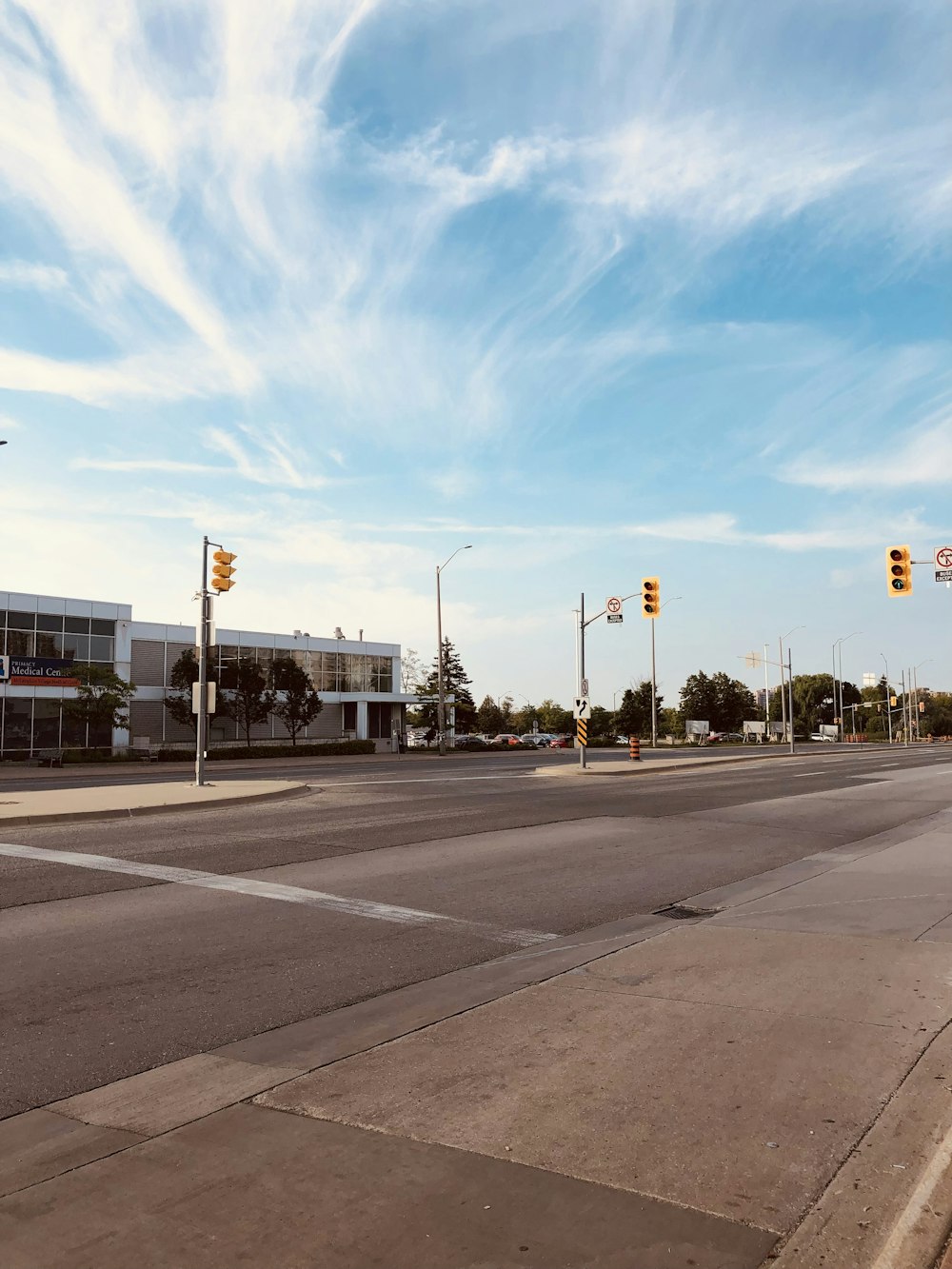 gray concrete road under blue sky during daytime