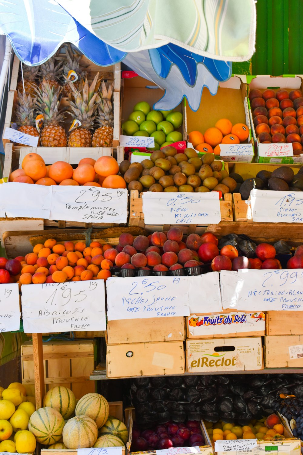 orange fruits on brown wooden crate