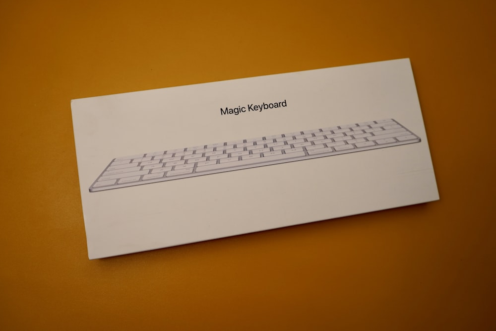 white keyboard on orange surface