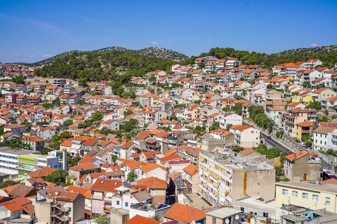 brown and white concrete houses on hill