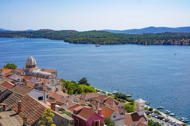 aerial view of city near body of water during daytime