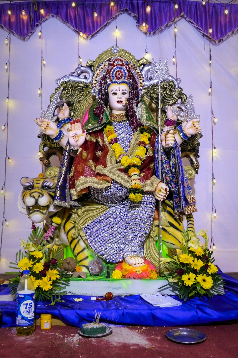 hindu deity figurine on blue and yellow floral textile