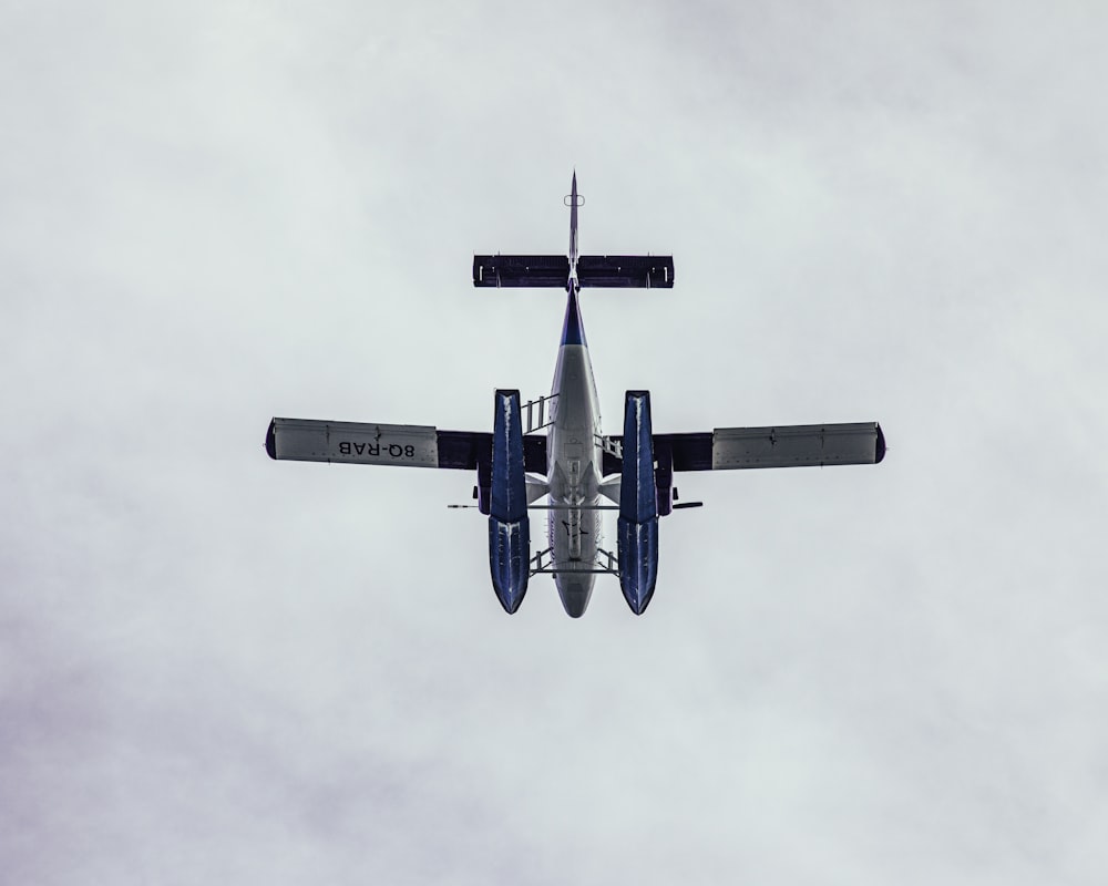 blue and white airplane flying in the sky