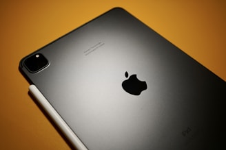 Colorful logo designs displayed on a digital tablet.