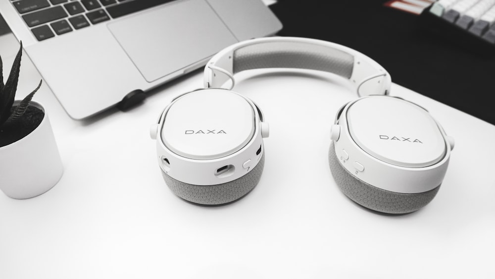 white and gray sony headphones